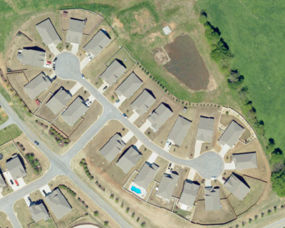 Completed residential courts in South Carolina with very little substantial canopy around visible homes.